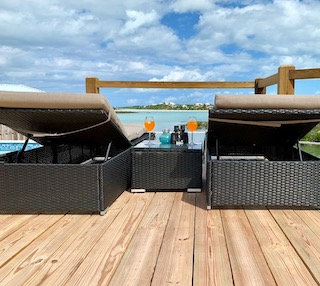 Enjoy the breeze and turquoise view from the loungers on front deck beside pool!